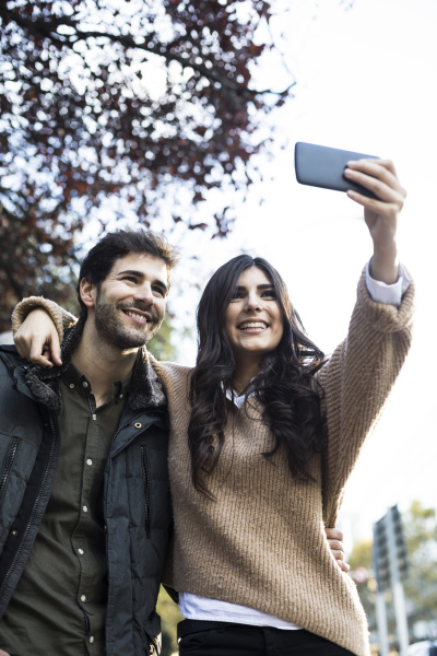 portrait of happy couple taking selfie