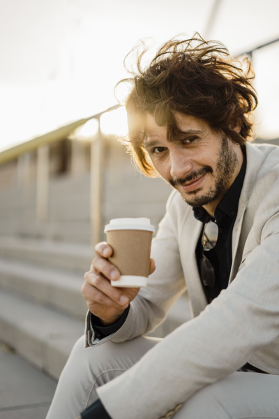 portrait of businessman with coffee to