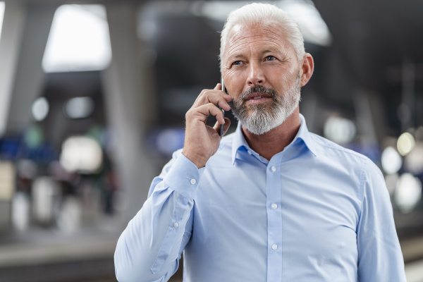 mature businessman talking on cell phone