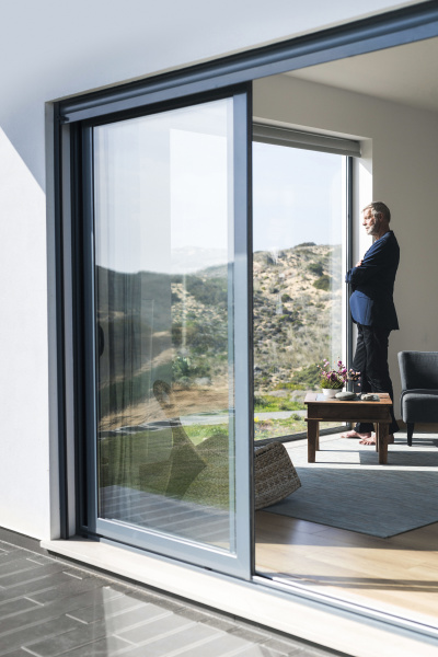 senior businessman standing at panorama window