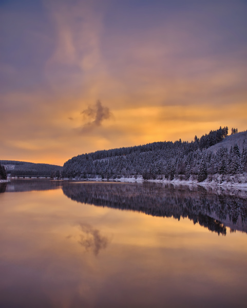winter evening at okertalsperre reservoir in