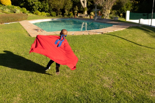 superhero boy in garden