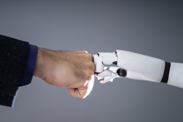 robot and human hand making fist