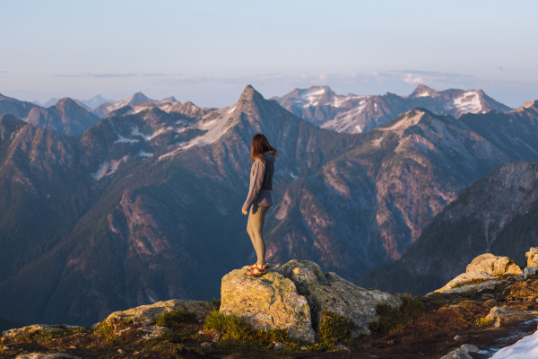 female hiker enjoying view on peak
