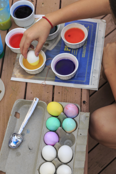 teenage girl coloring easter eggs
