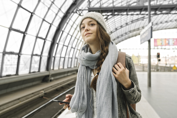 young woman waiting at the station