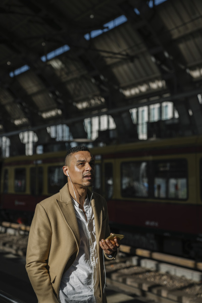 portrait of businessman standing at train