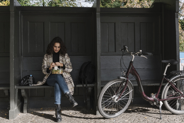 woman, with, bicycle, having, lunch, break - 28018460