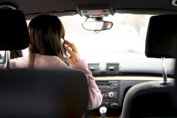 businesswoman using smartphone in the car