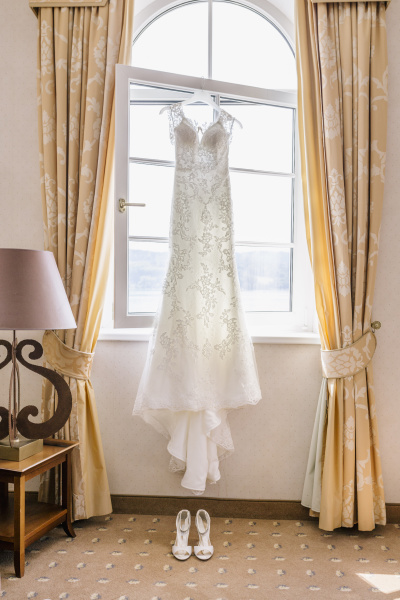 wedding dress hanging in front of