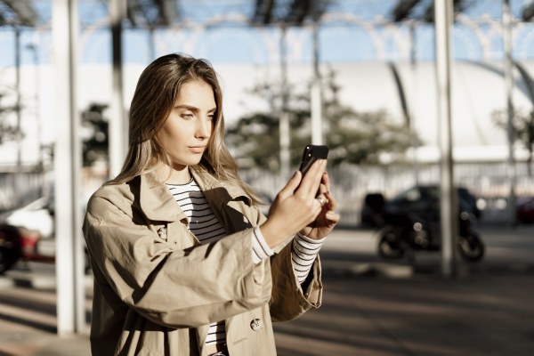 young blond woman using smartphone and