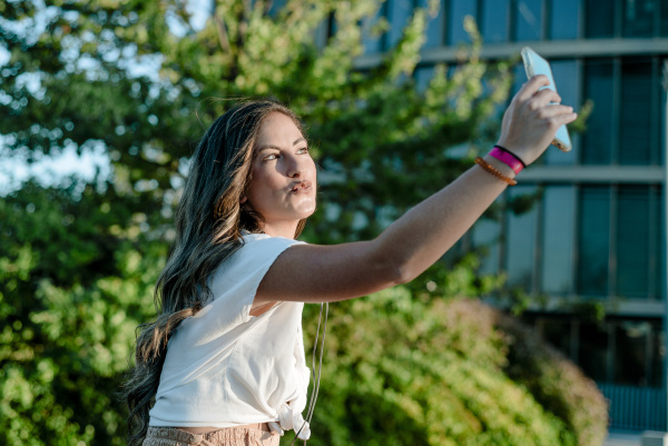 young woman taking a selfie with