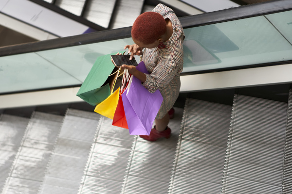 young, woman, holding, colorful, shopping, bags - 28032195