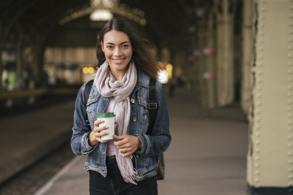 young female traveller with coffee to