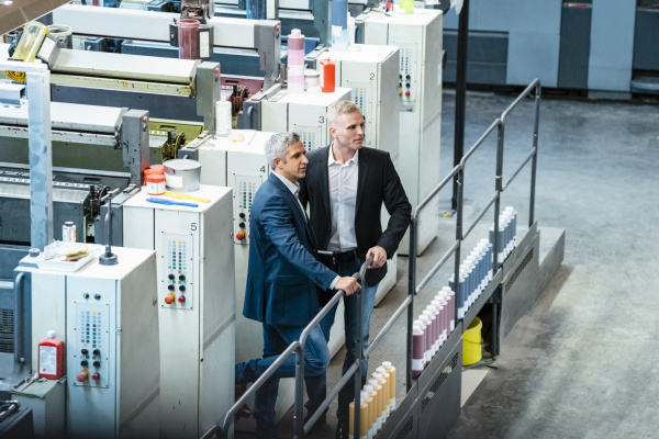 two businessmen in a printing shop
