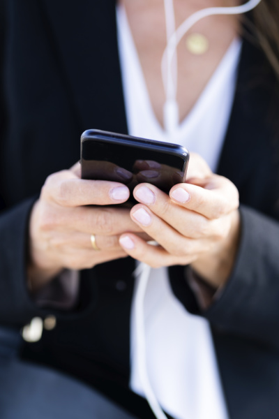 close up of businesswoman using smartphone