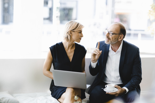 businessman and woman sitting in coffee