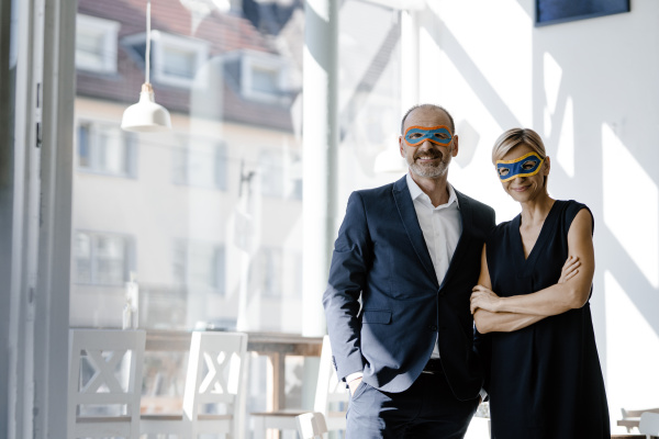 businessman and woman wearing super hero