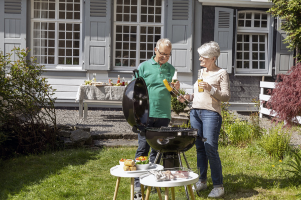 happy senior couple having a barbecue