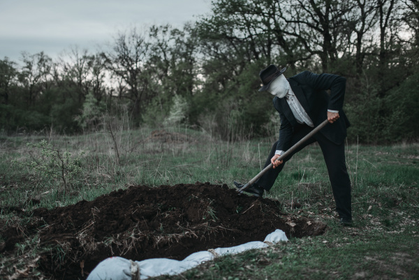 Bloody Murderer Is Digging A Grave For The Victim Stock Image 