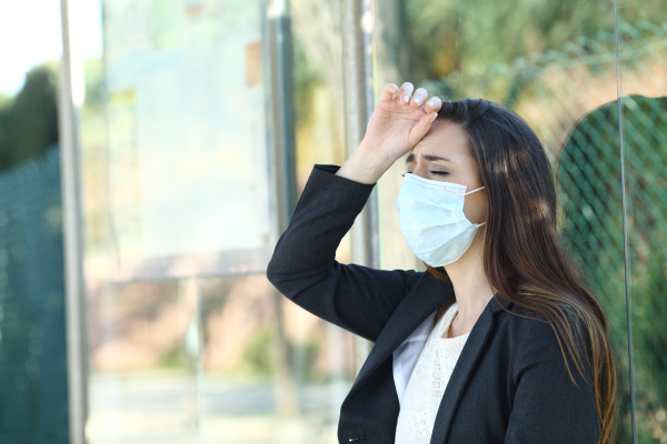 woman wearing a mask complaining suffering