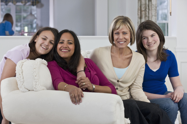 two mothers with their daughters sitting