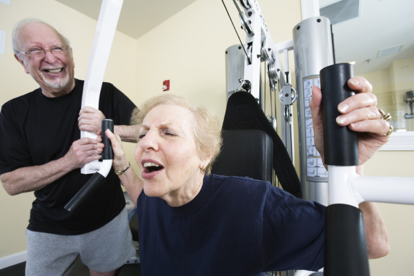senior couple exercising in the gym