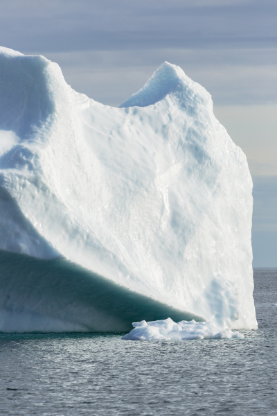 majestic melting iceberg on sunny ocean