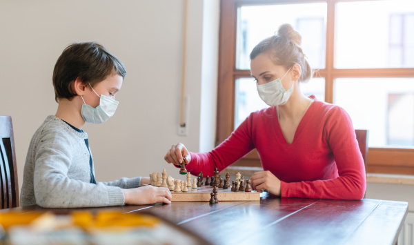 mother and son playing chess to