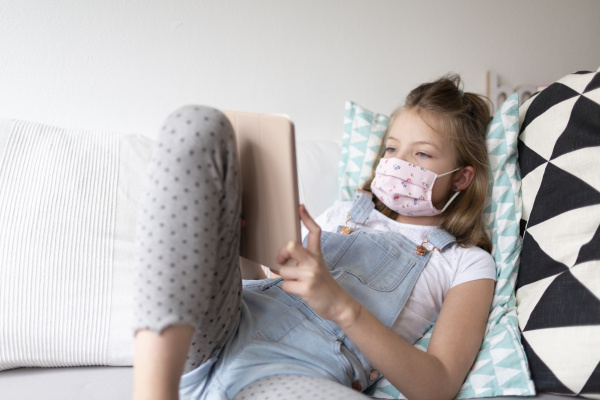 young girl with pink protective mask