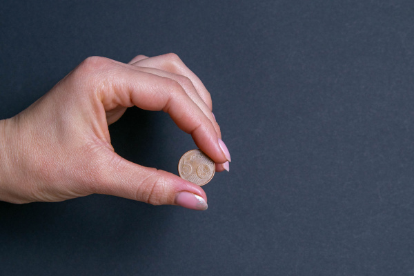hand sign by holding a coin