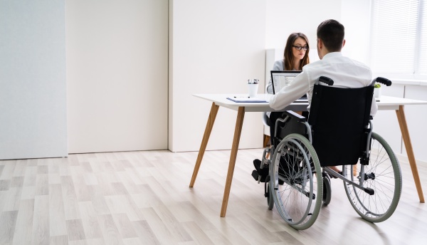 disabled businesswoman sitting with her partner