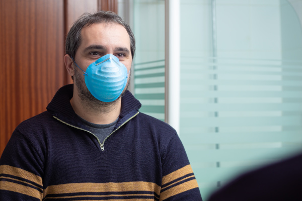 worried man with medical mask looking