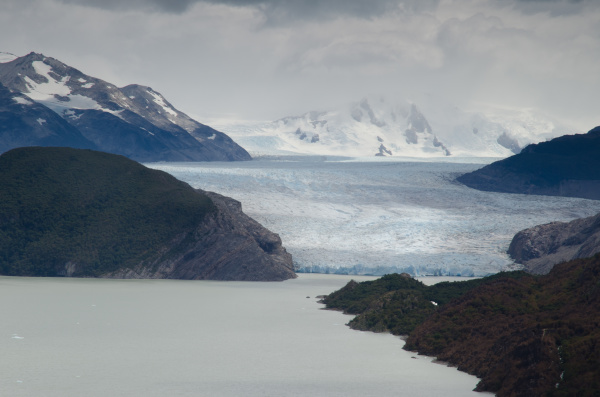 grey lake and grey glacier in
