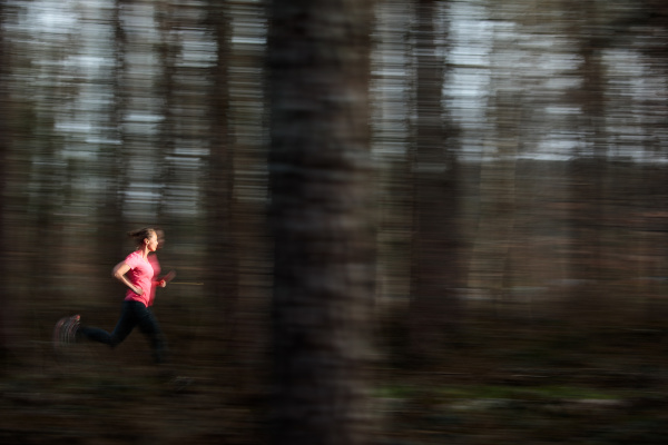 young woman running outdoors in a