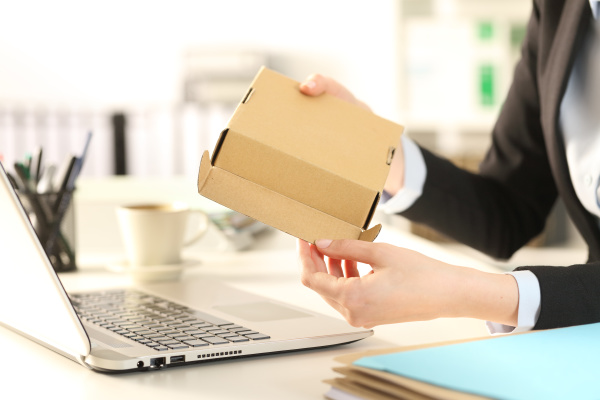 business woman hands opens package at