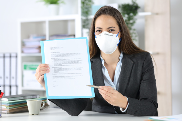 executive with mask showing contract at