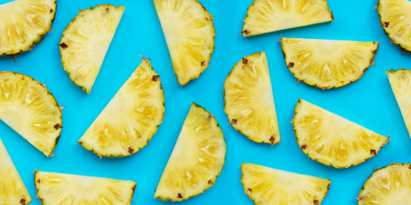 fresh pineapple slices on blue background