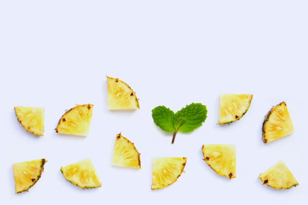 fresh pineapple slices with mint leaves