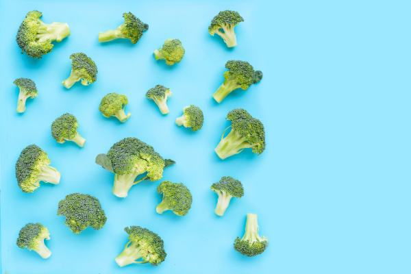 fresh green broccoli on blue background