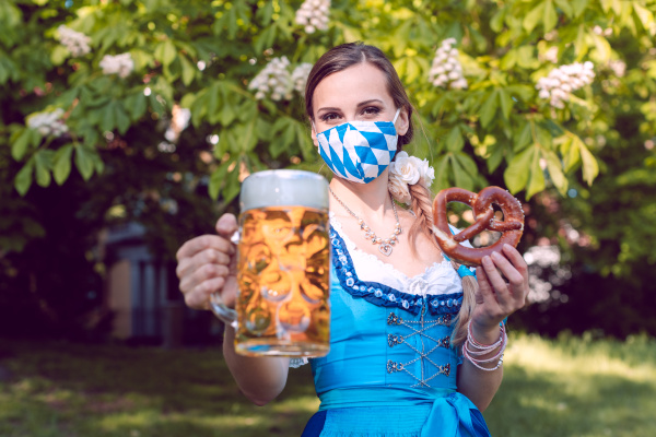 bavarian woman toasting with beer during