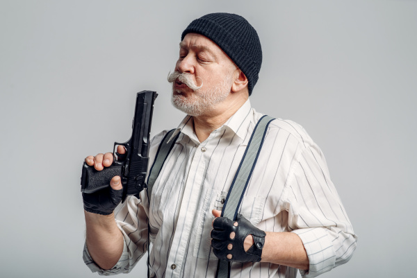 elderly man with gun isolated on