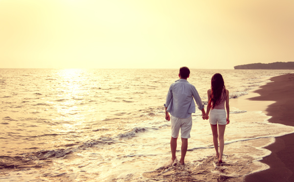 young couple walking on the beach