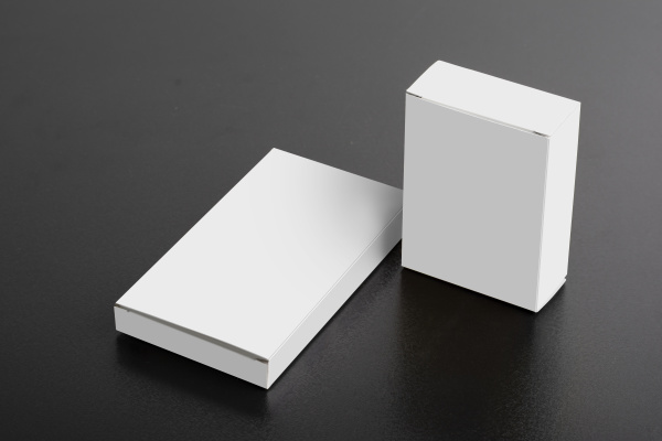 two pillboxes packages on dark background