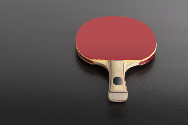 table tennis racket on black background