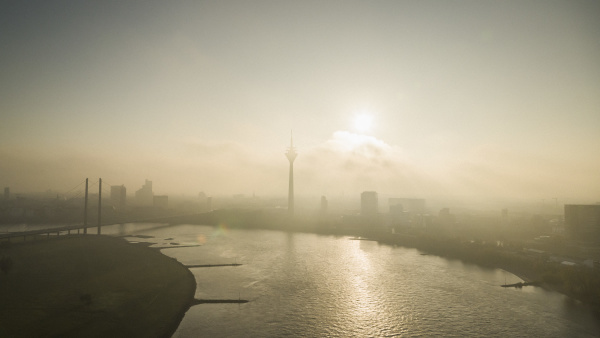 sunset over silhouetted duesseldorf cityscape and