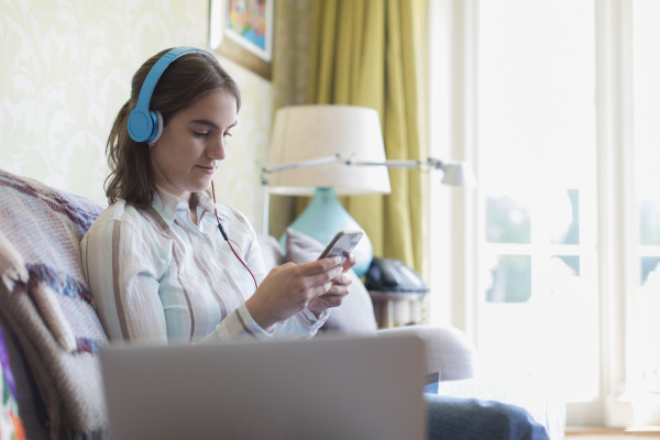 teenage girl with headphones and smart