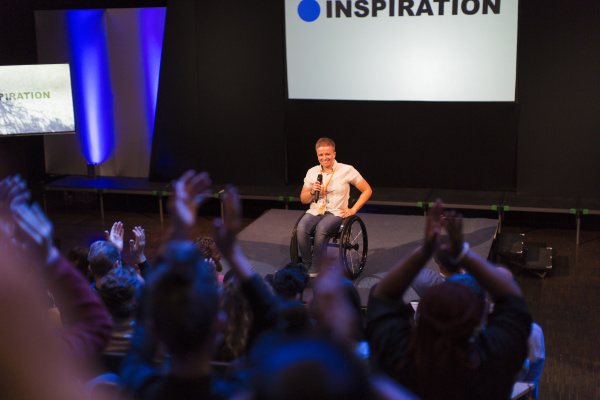 female speaker in wheelchair on stage