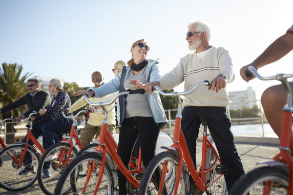 active senior tourist friends bike riding