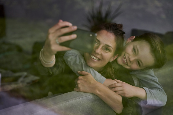 mother taking selfie with son while
